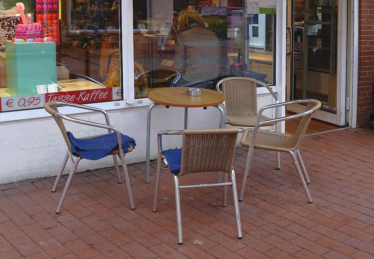 Empty chairs around a small cafe table
