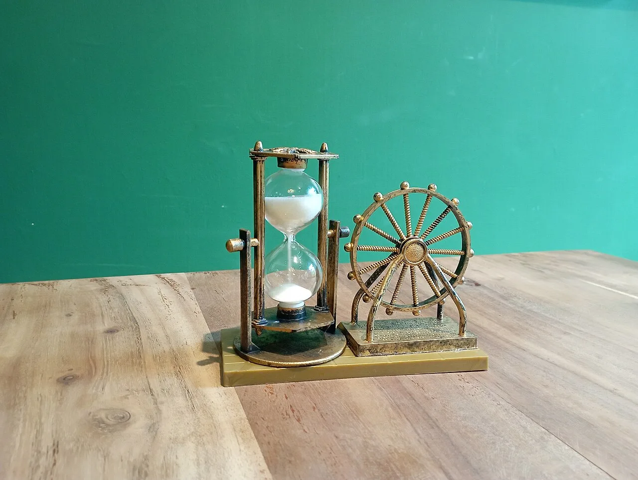 A decorative hourglass on a wooden table