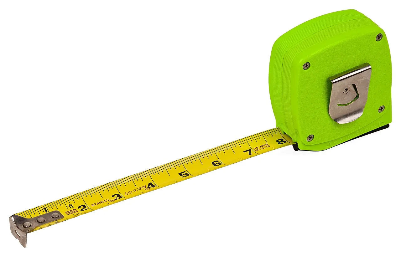 A measuring tape extended across a plain background
