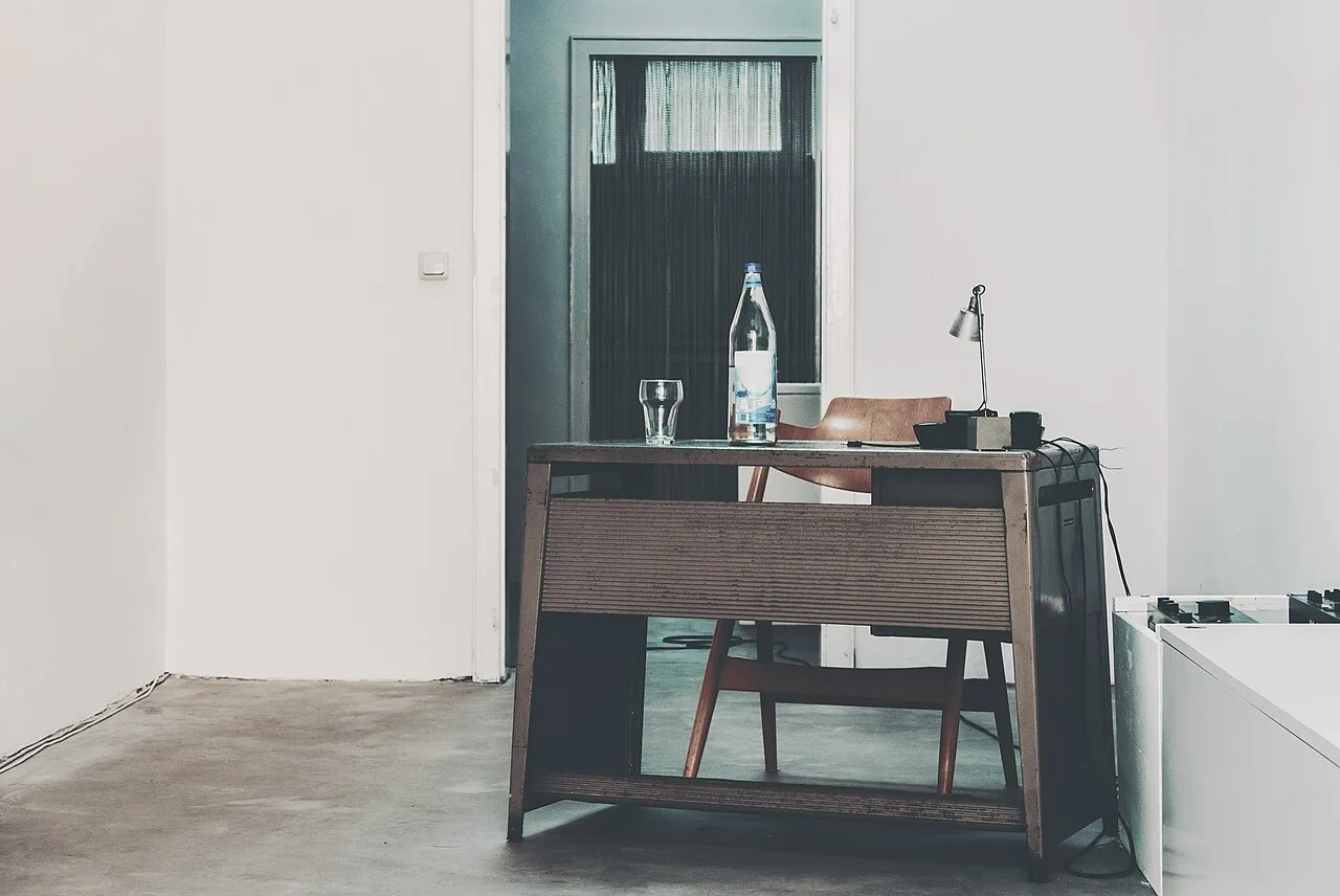 A simple desk and chair in a bright room