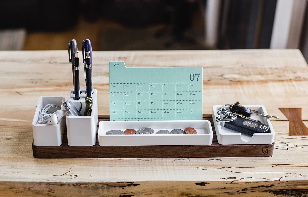Pens, notes, and small objects arranged in a desk organizer