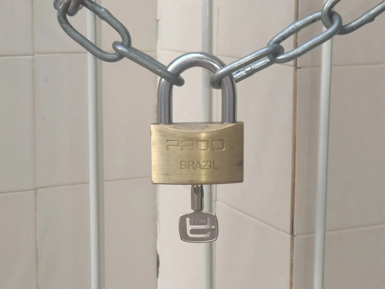 A padlock securing a metal chain