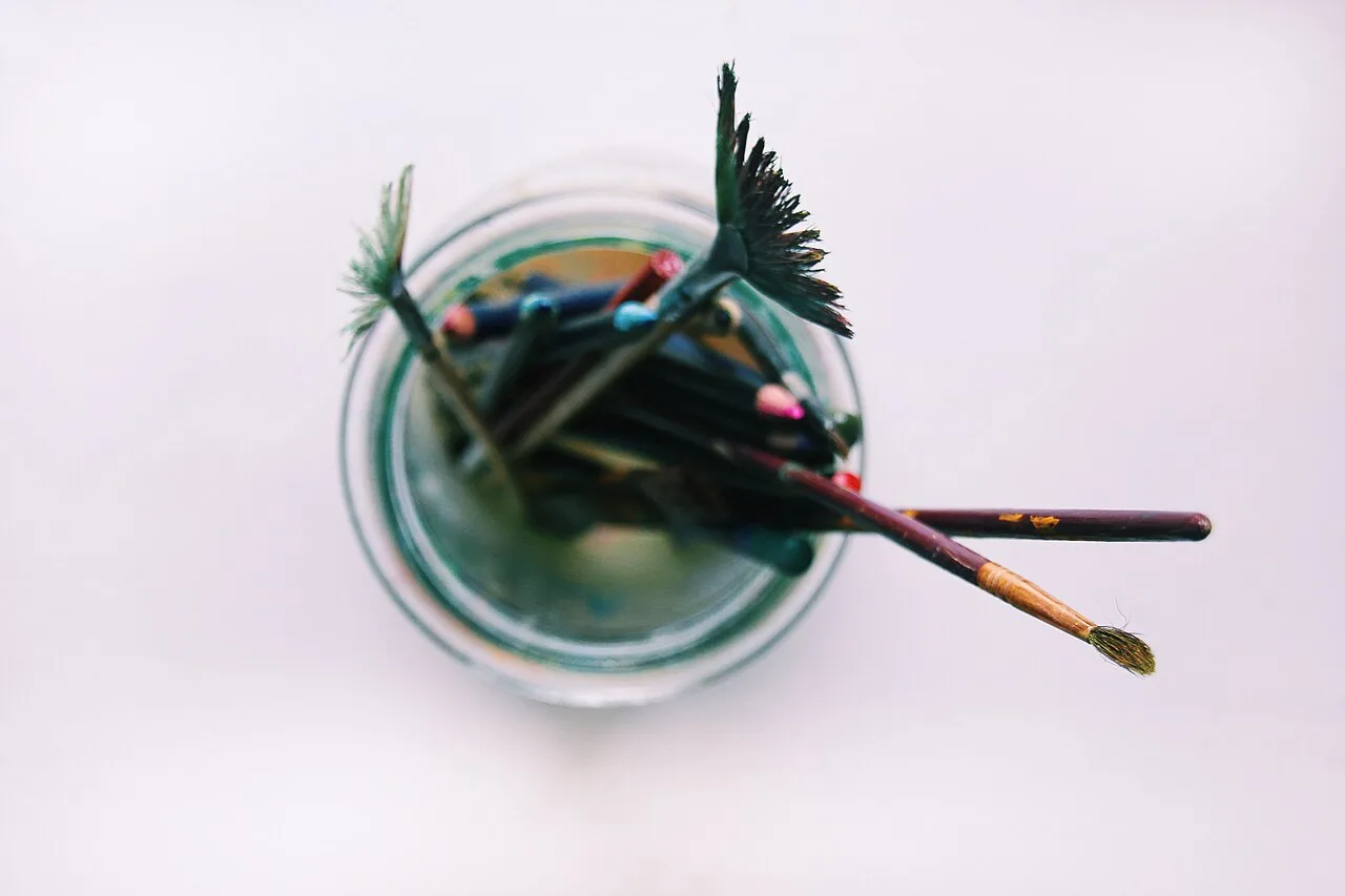 Paintbrushes standing in a glass jar