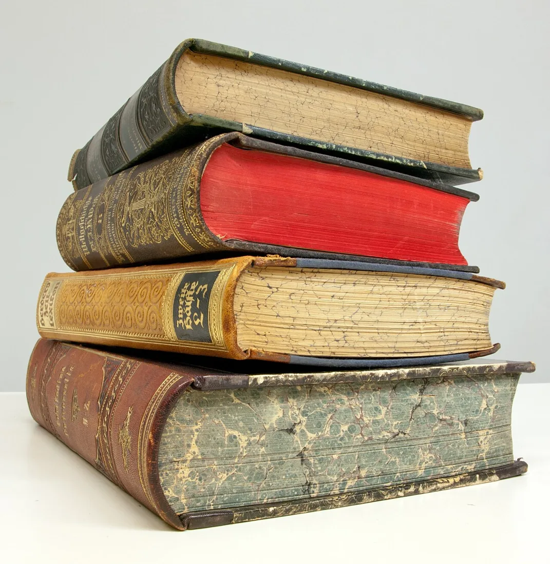 A small stack of worn hardcover books